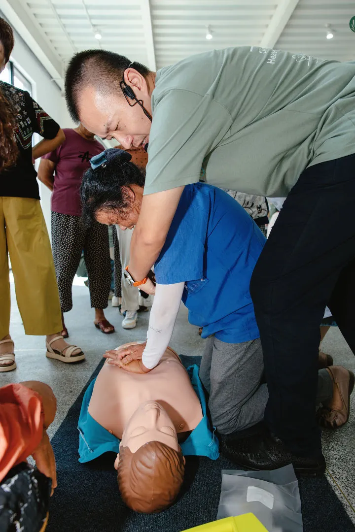A participant practising CPR on a training mannequin