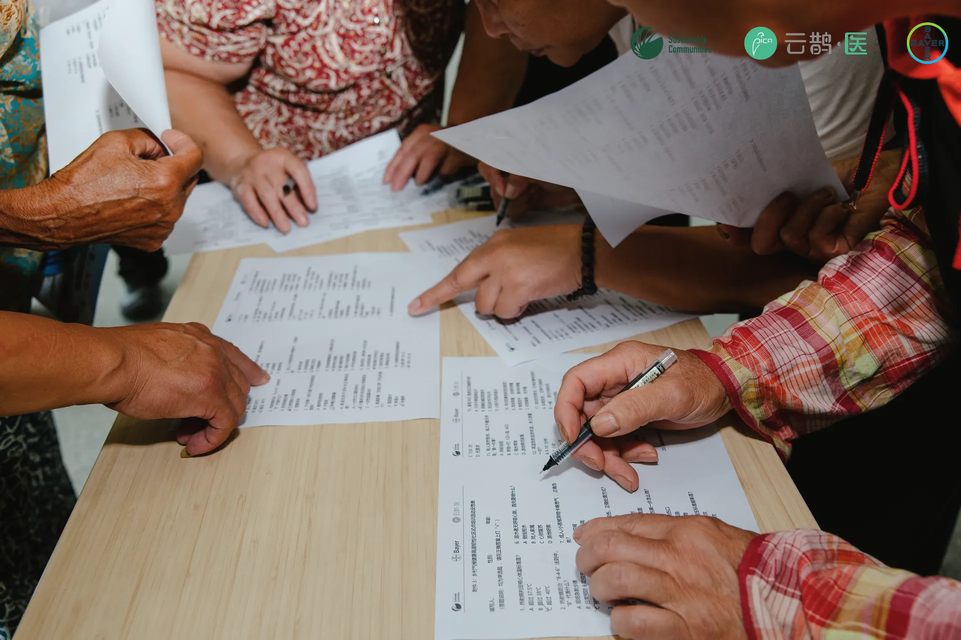 Participants working together through printed training materials